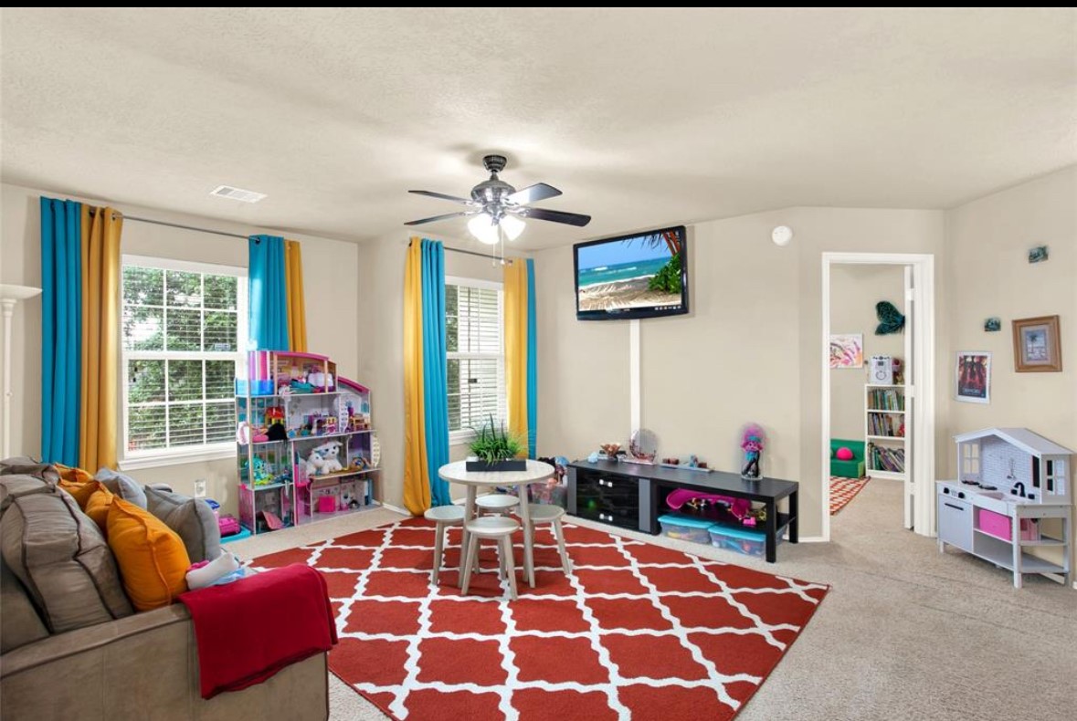 7035 Primrose Road Baytown, TX 77521 - Photo 11 of 18 a bedroom with furniture and a rug