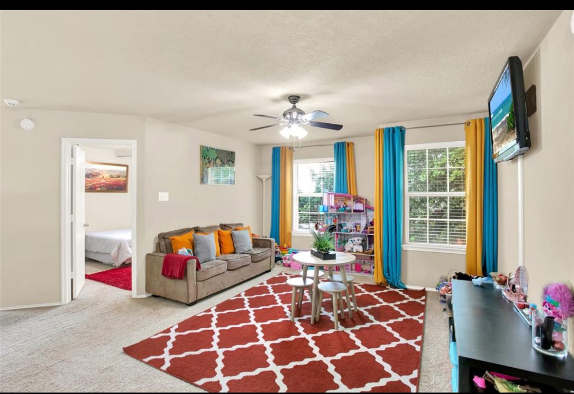 7035 Primrose Road Baytown, TX 77521 - Photo 12 of 18 a bedroom with a bed and a chandelier