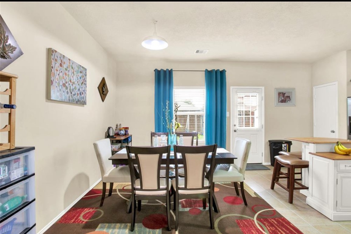 7035 Primrose Road Baytown, TX 77521 - Photo 8 of 18 a dining room with furniture and wooden floor