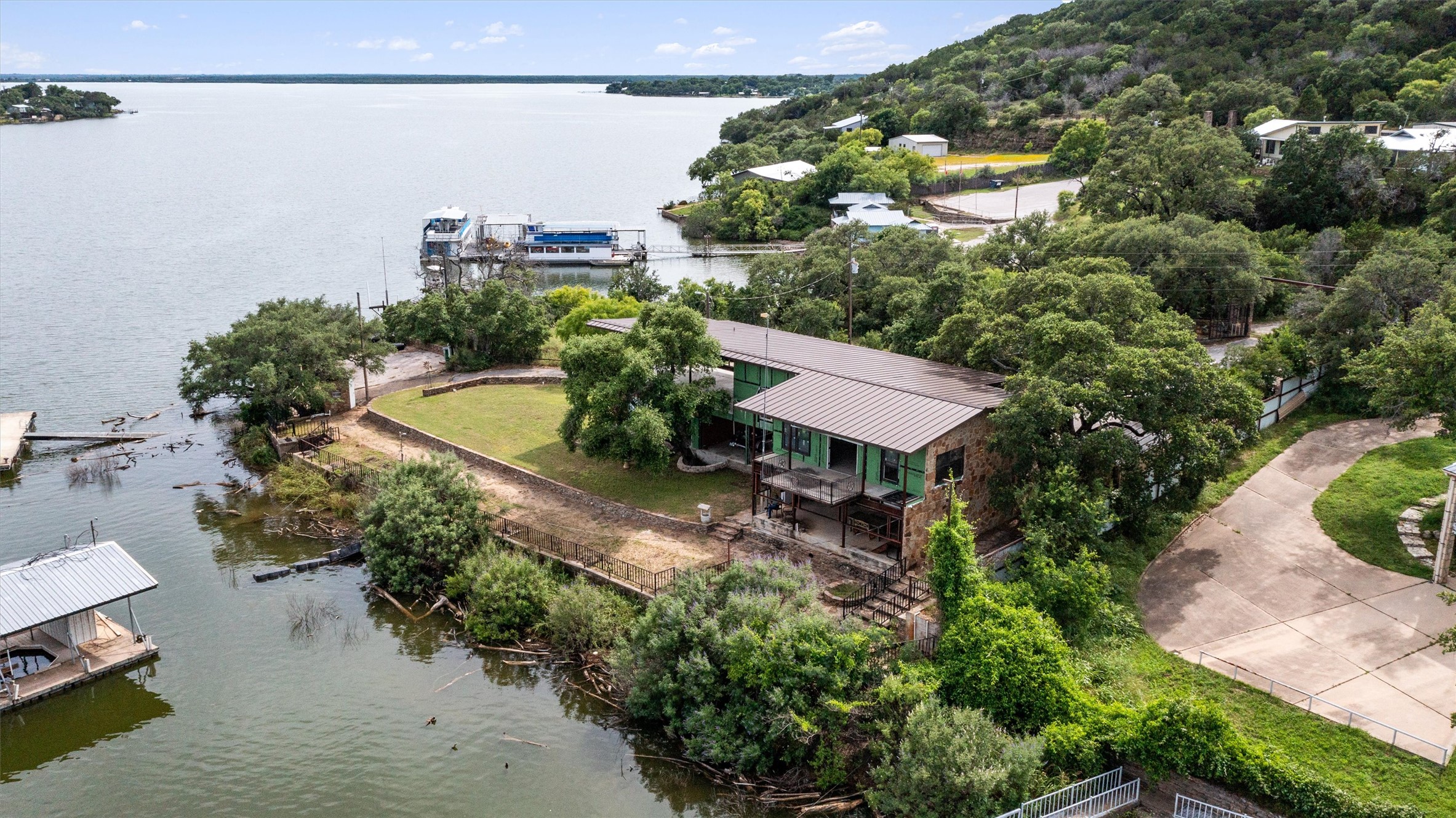 325 Eagle Rest Burnet, TX 78611 - Photo 1 of 40 A private lakefront residence nestled among mature trees offers serene water views.