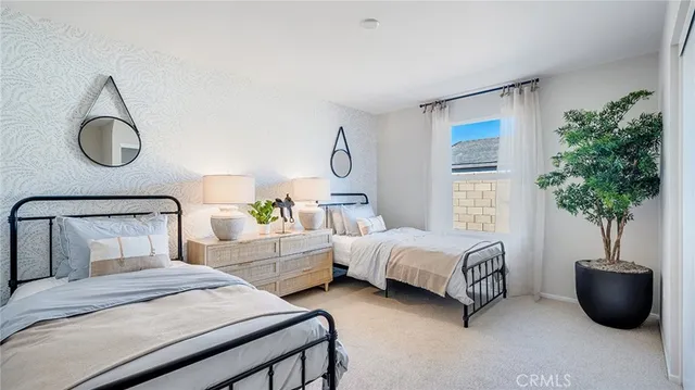 a bedroom with bed and a potted plant