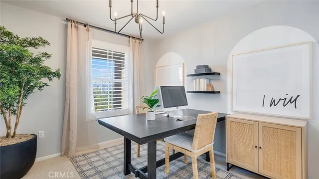 a view of a dining room with furniture and window
