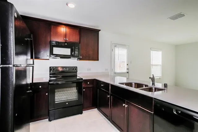 a kitchen with a sink and cabinets