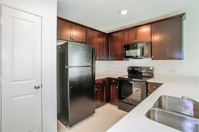 a kitchen with stainless steel appliances granite countertop a refrigerator and a sink