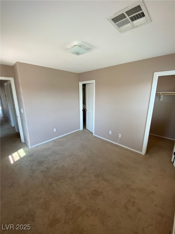 5817 Addy Lane, Unit N North Las Vegas, NV 89081 - Photo 18 of 32 Unfurnished bedroom with a walk in closet and carpet