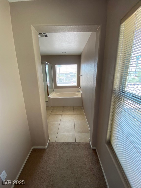 5817 Addy Lane, Unit N North Las Vegas, NV 89081 - Photo 24 of 32 Hallway featuring light colored carpet and light tile patterned flooring