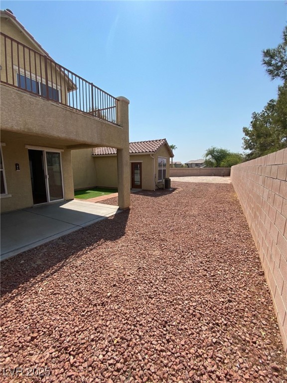 5817 Addy Lane, Unit N North Las Vegas, NV 89081 - Photo 27 of 32 Fenced backyard with a patio area