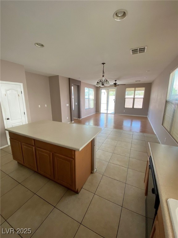 5817 Addy Lane, Unit N North Las Vegas, NV 89081 - Photo 32 of 32 Kitchen with pendant lighting, open floor plan, light countertops, a ceiling fan, and light tile patterned flooring