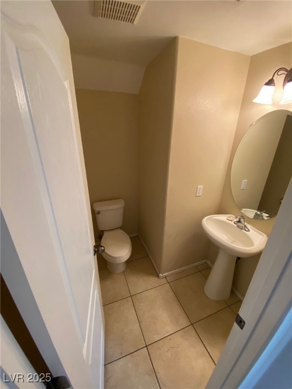 5817 Addy Lane, Unit N North Las Vegas, NV 89081 - Photo 7 of 32 Half bathroom with light tile patterned flooring and toilet