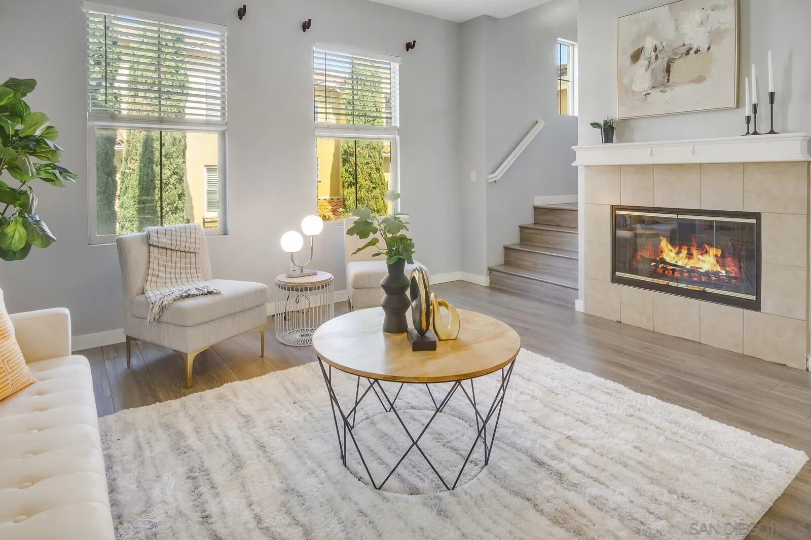 a living room with furniture a dining table and a fireplace