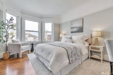 a bedroom with a large bed and a large window