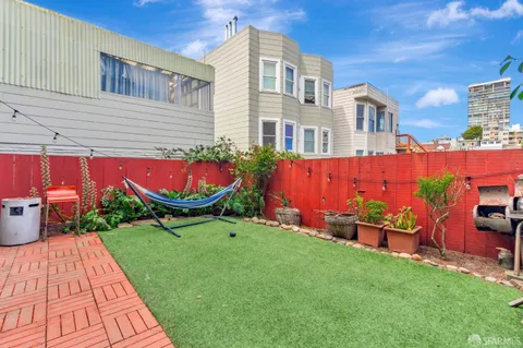 a backyard of a house with outdoor seating