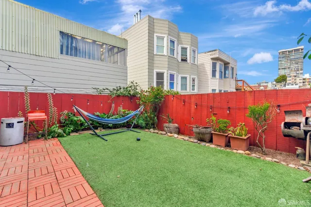 a backyard of a house with outdoor seating