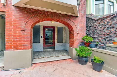 a view of a room with wooden floor table and chairs