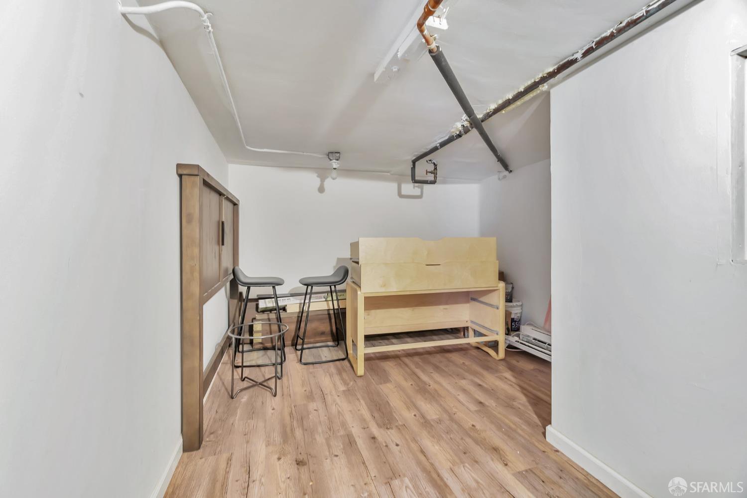 1180 Jackson Street, Unit 6 San Francisco, CA 94109 - Photo 46 of 48 a view of a room with wooden floor table and chairs