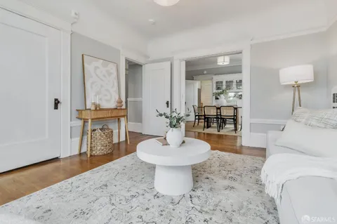 a living room with furniture a mirror and a lamp