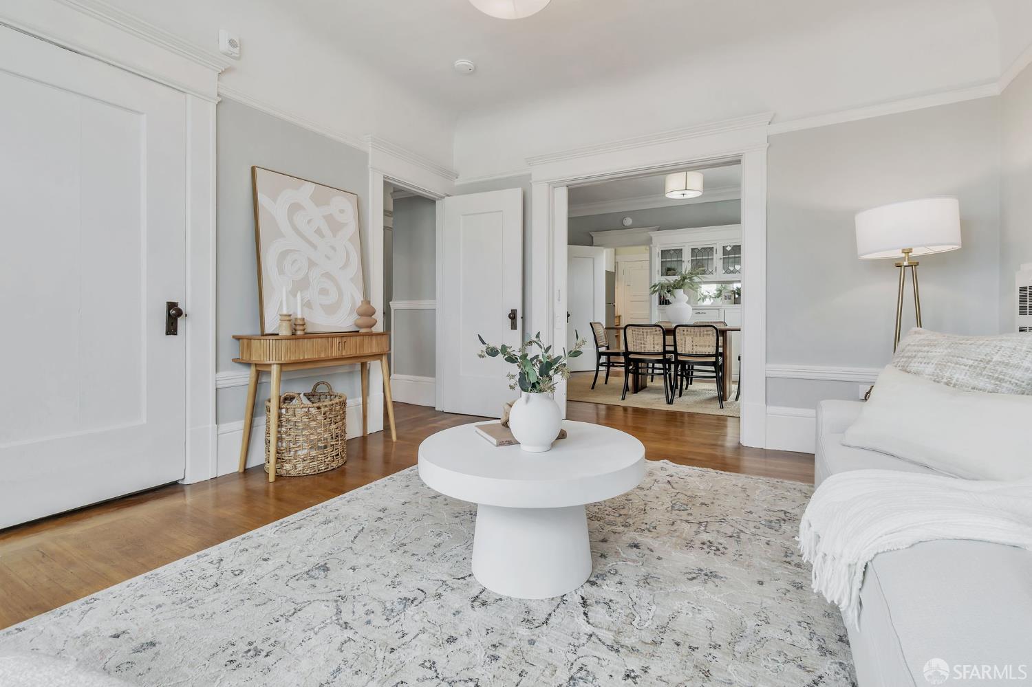 1180 Jackson Street, Unit 6 San Francisco, CA 94109 - Photo 6 of 48 a living room with furniture a mirror and a lamp