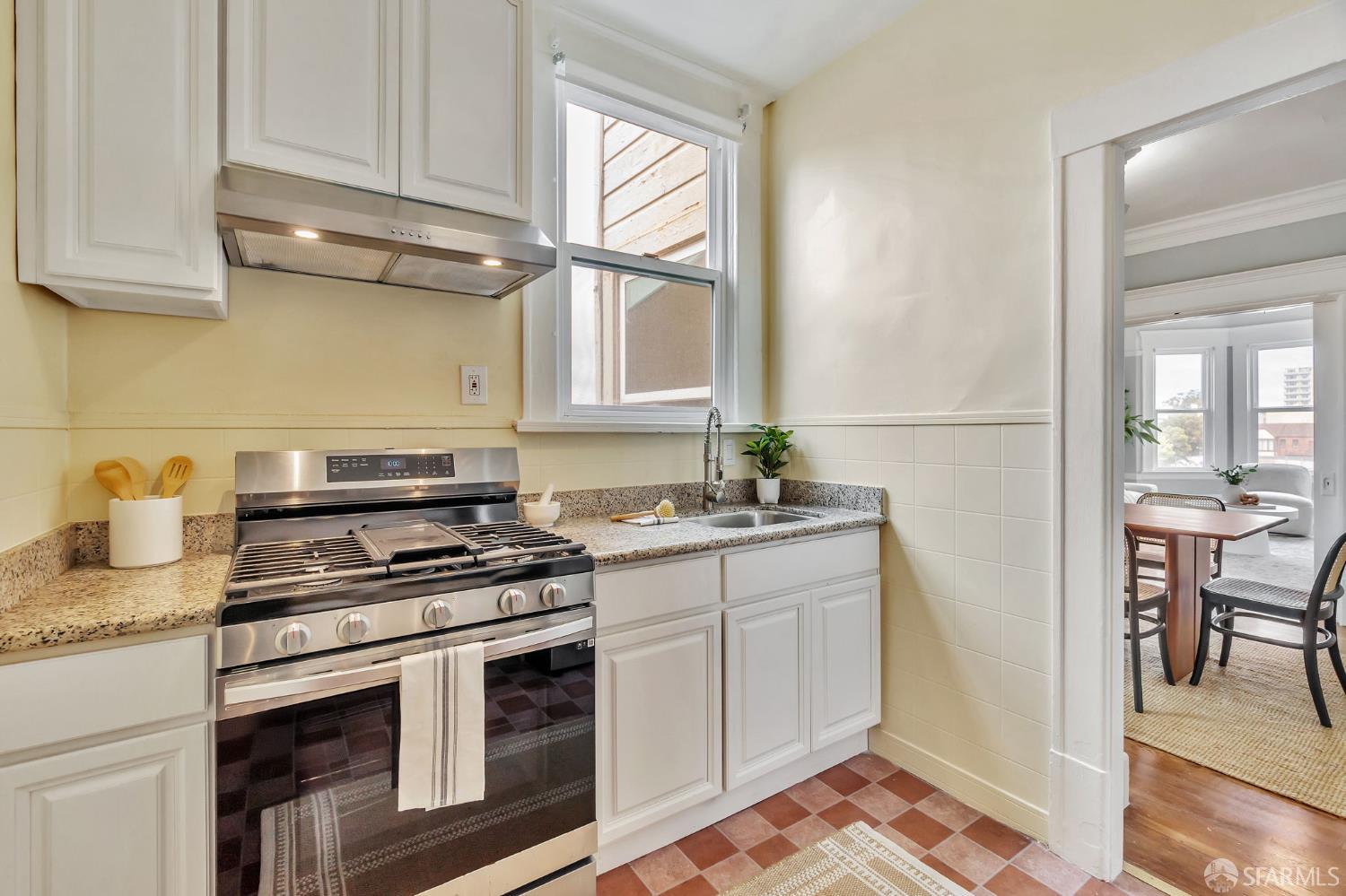 1180 Jackson Street, Unit 6 San Francisco, CA 94109 - Photo 10 of 48 a kitchen with stainless steel appliances granite countertop a sink stove and cabinets