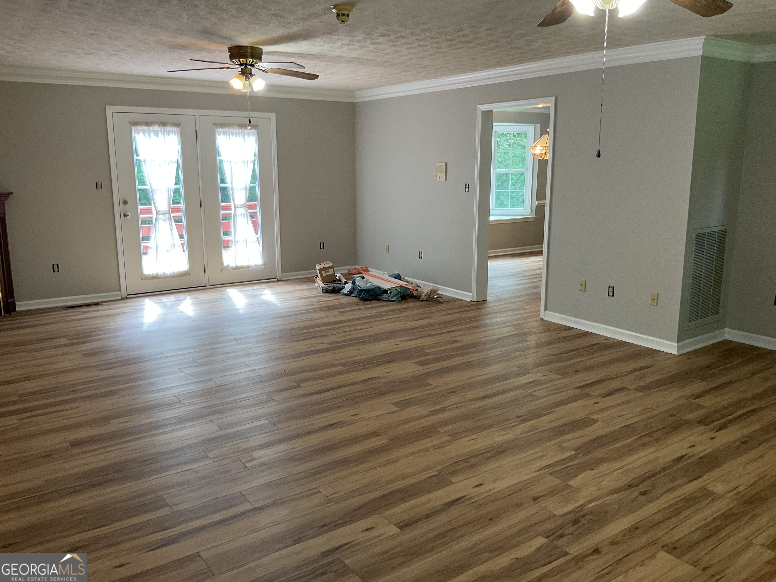 4800 Bethlehem Road Fairburn, GA 30213 - Photo 22 of 49 an empty room with wooden floor and windows
