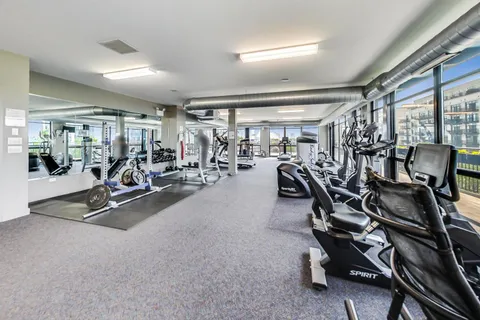 a view of roof deck with wooden floor and seating space