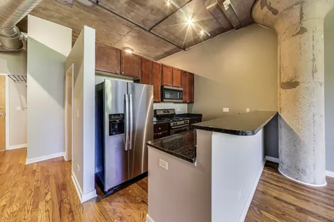 a kitchen with a refrigerator and a sink