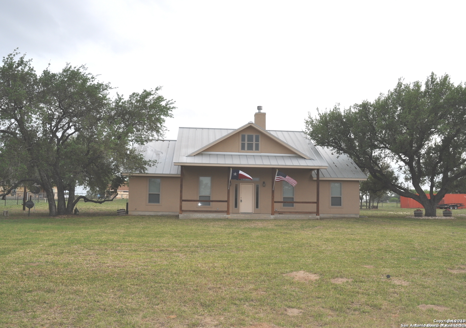 229 County Road 7756 Devine, TX 78016 - Photo 1 of 1 a front view of a house with a garden and trees
