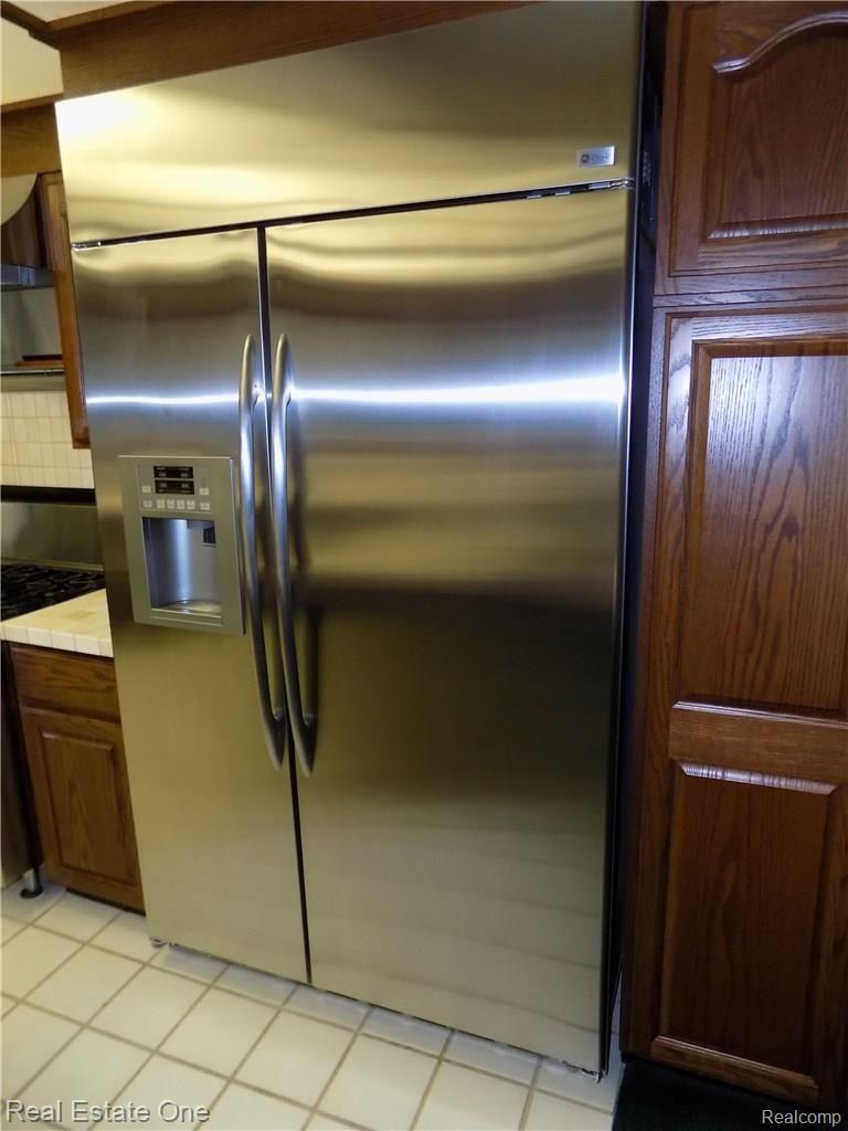 4650 Clyde Road Holly, MI 48442 - Photo 15 of 68 The GE Profile industrial size side by side refrigerator- freezer