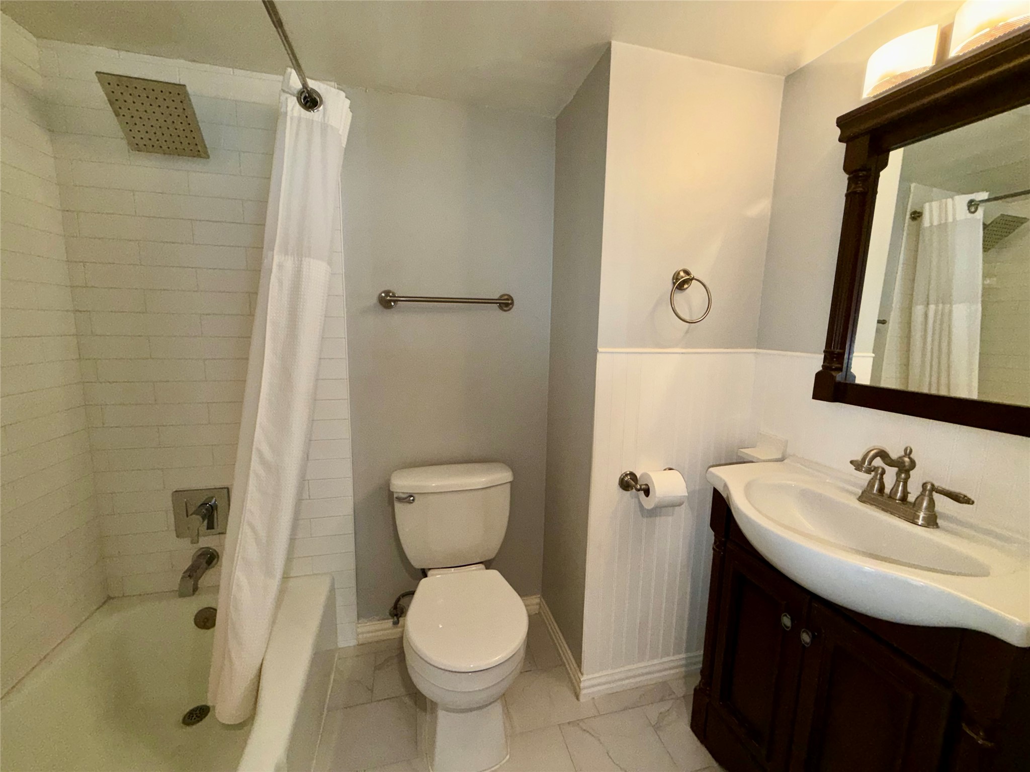 2918 Ranch Road 620 North, Unit C120 Austin, TX 78734 - Photo 13 of 34 Downstairs full bath offers a bathtub, dark wood vanity, tile floors & offers essential comfort and function.