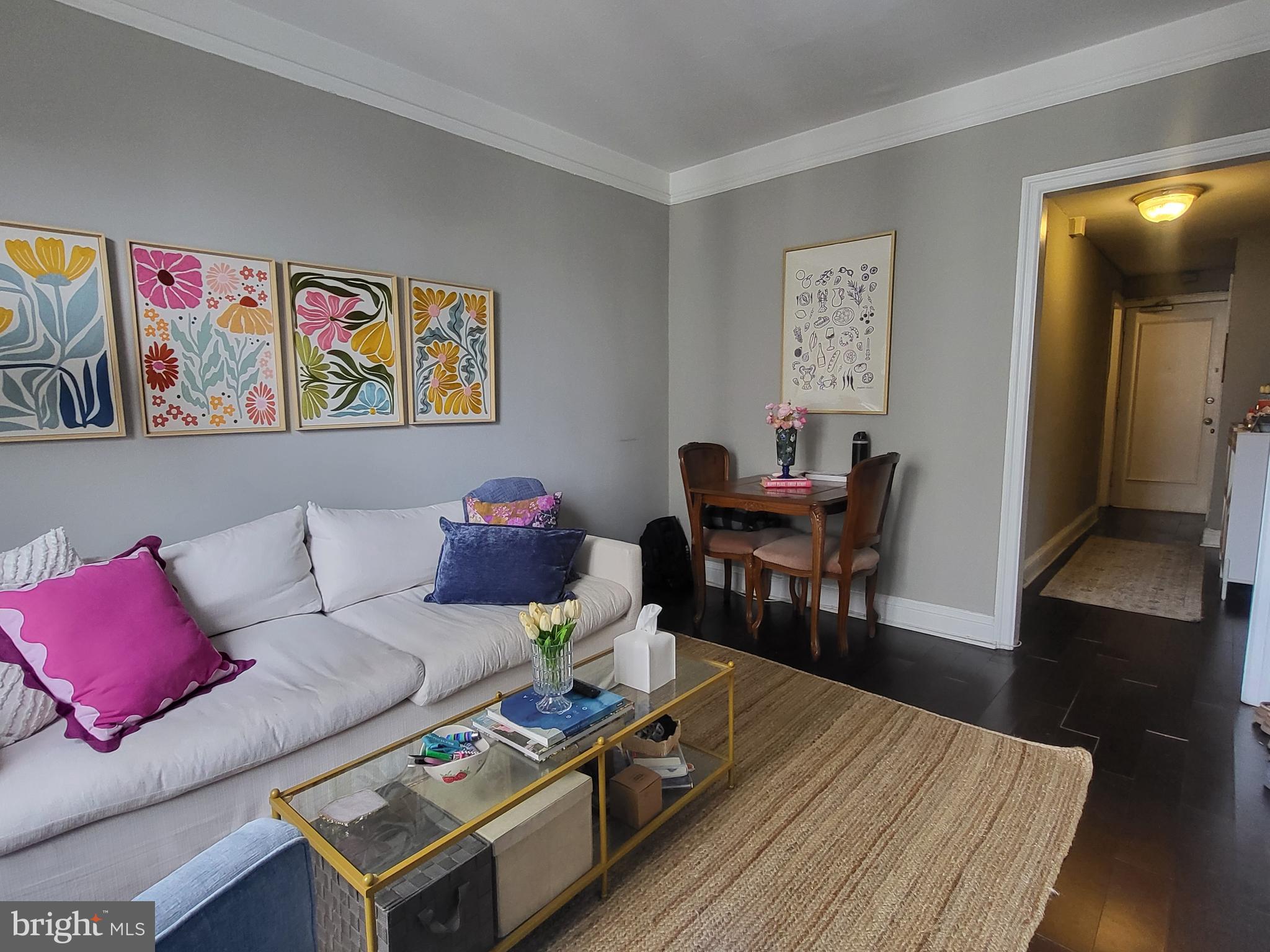 2031 Locust Street, Unit 1005 Philadelphia, PA 19103 - Photo 4 of 15 a living room with furniture and wooden floor