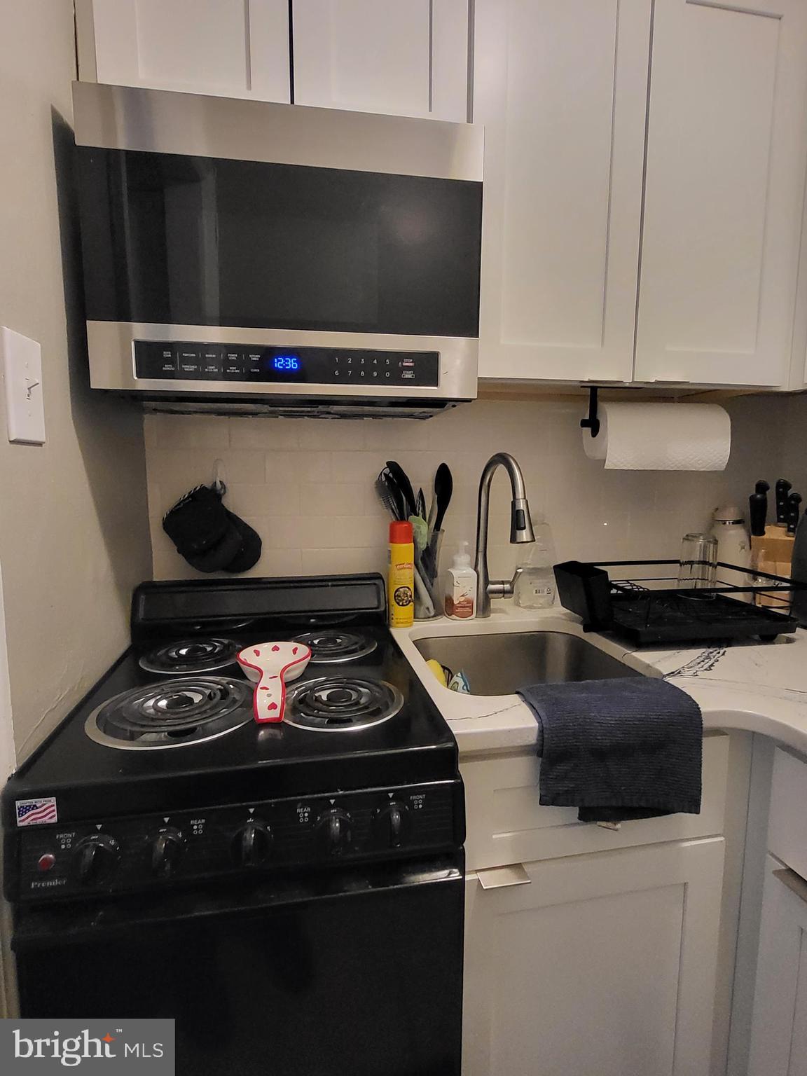 2031 Locust Street, Unit 1005 Philadelphia, PA 19103 - Photo 6 of 15 a kitchen with a stove and a refrigerator
