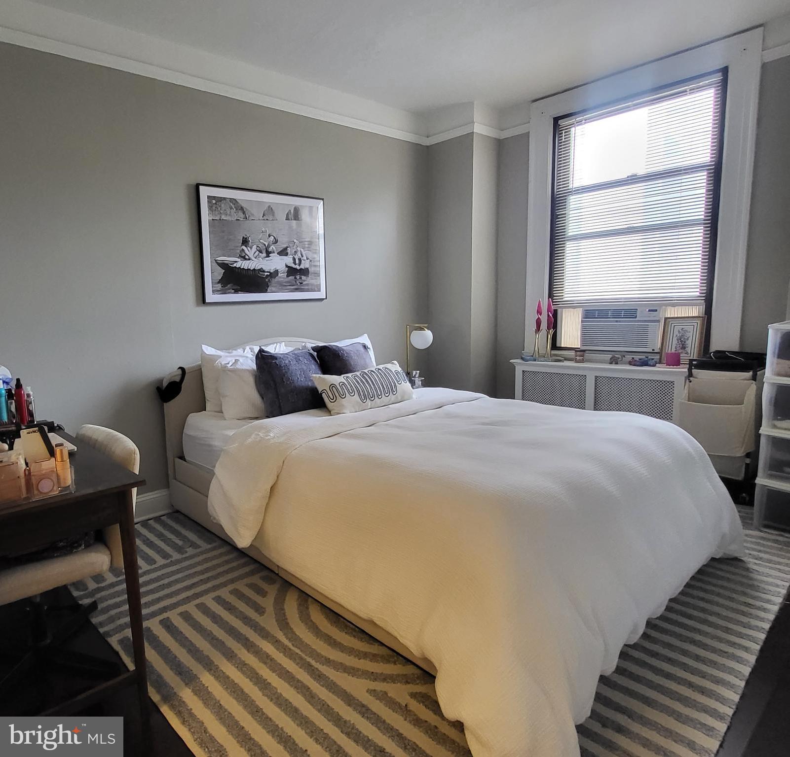 2031 Locust Street, Unit 1005 Philadelphia, PA 19103 - Photo 7 of 15 a bedroom with bed and a window