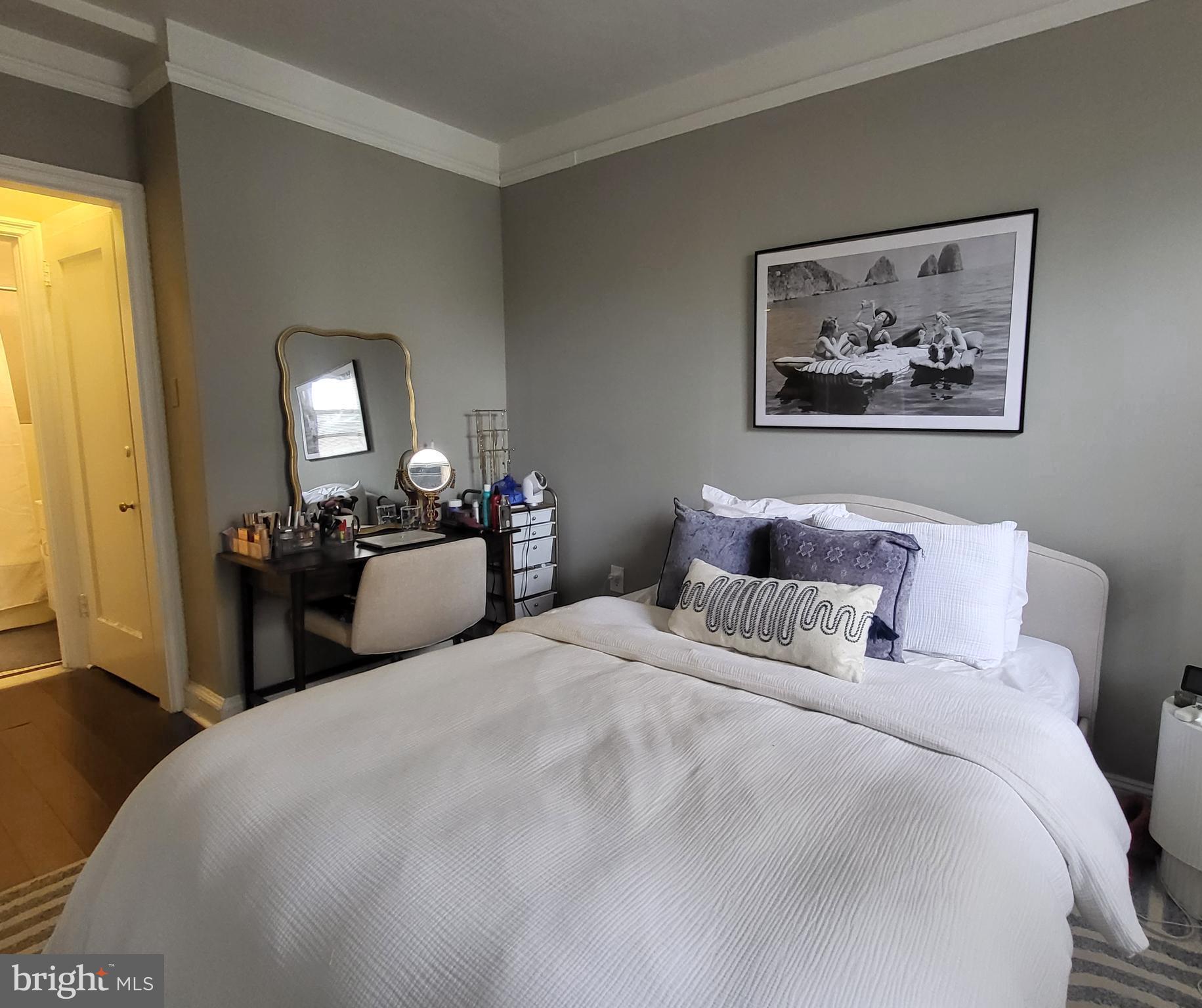 2031 Locust Street, Unit 1005 Philadelphia, PA 19103 - Photo 8 of 15 a bedroom with bed and a chandelier