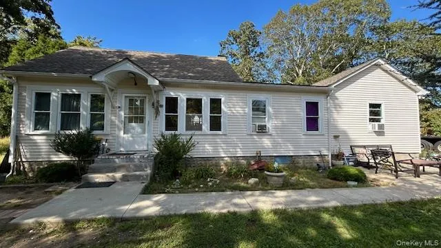 a front view of a house with a yard outdoor seating and mountain view