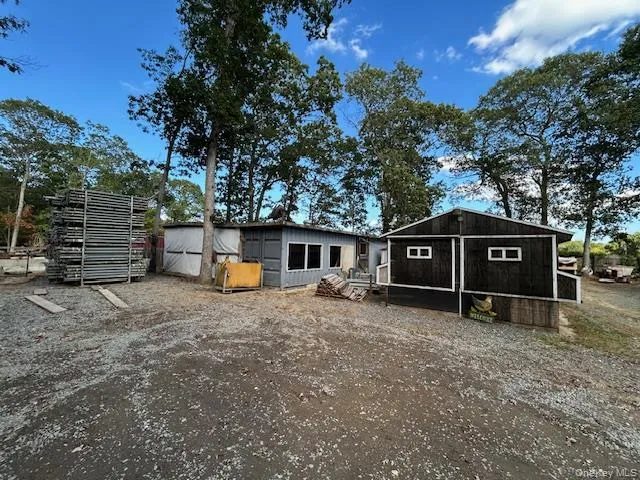 a view of a house with a yard and wooden fence