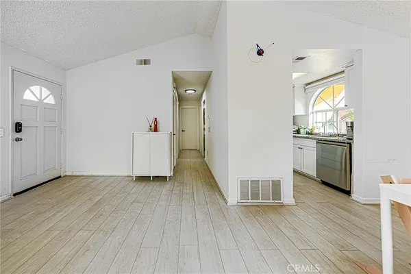 a view of a hallway with wooden floor and closet