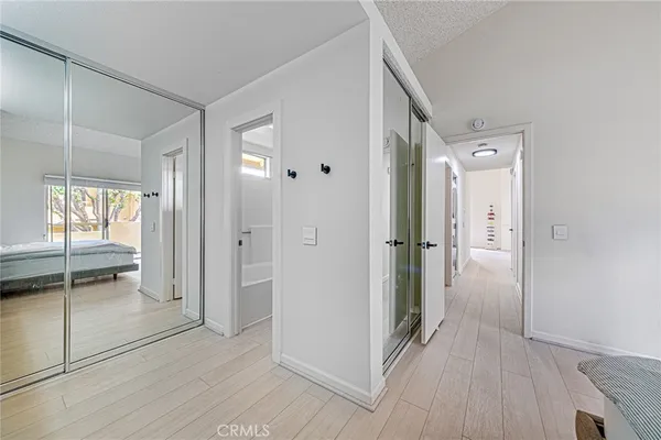 a view of a hallway with wooden cabinets