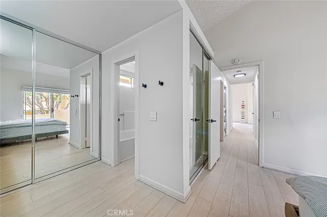 a view of a hallway with wooden cabinets