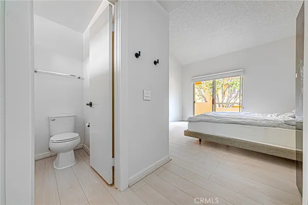 a white toilet sitting next to a bath tub