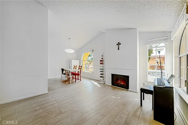 an empty room with furniture fireplace and wooden floor