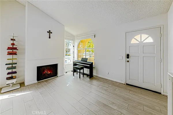 wooden floor fireplace and natural light in room