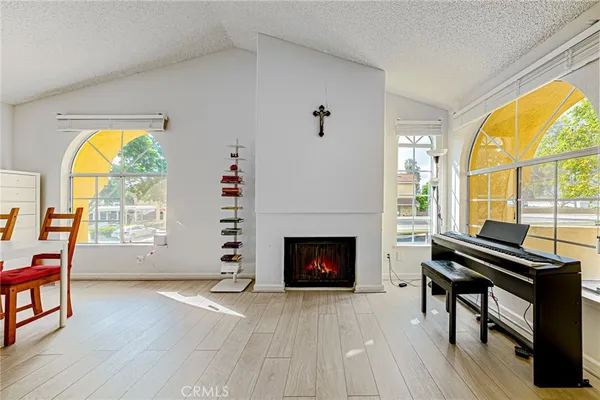 a living room with furniture a fireplace and a large window