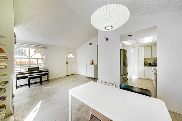 a kitchen with stainless steel appliances granite countertop a refrigerator a stove and a sink