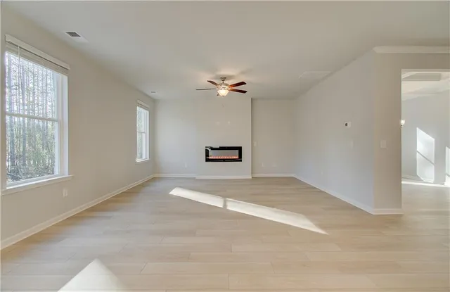 a view of a livingroom with a ceiling fan and window