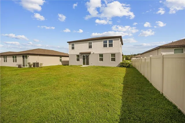 a view of house with a yard
