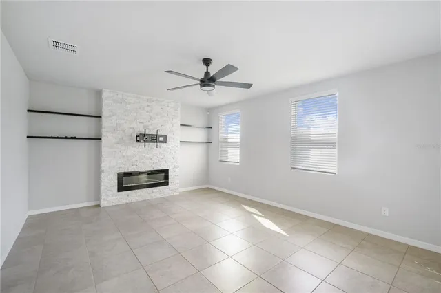 a view of an empty room with a kitchen