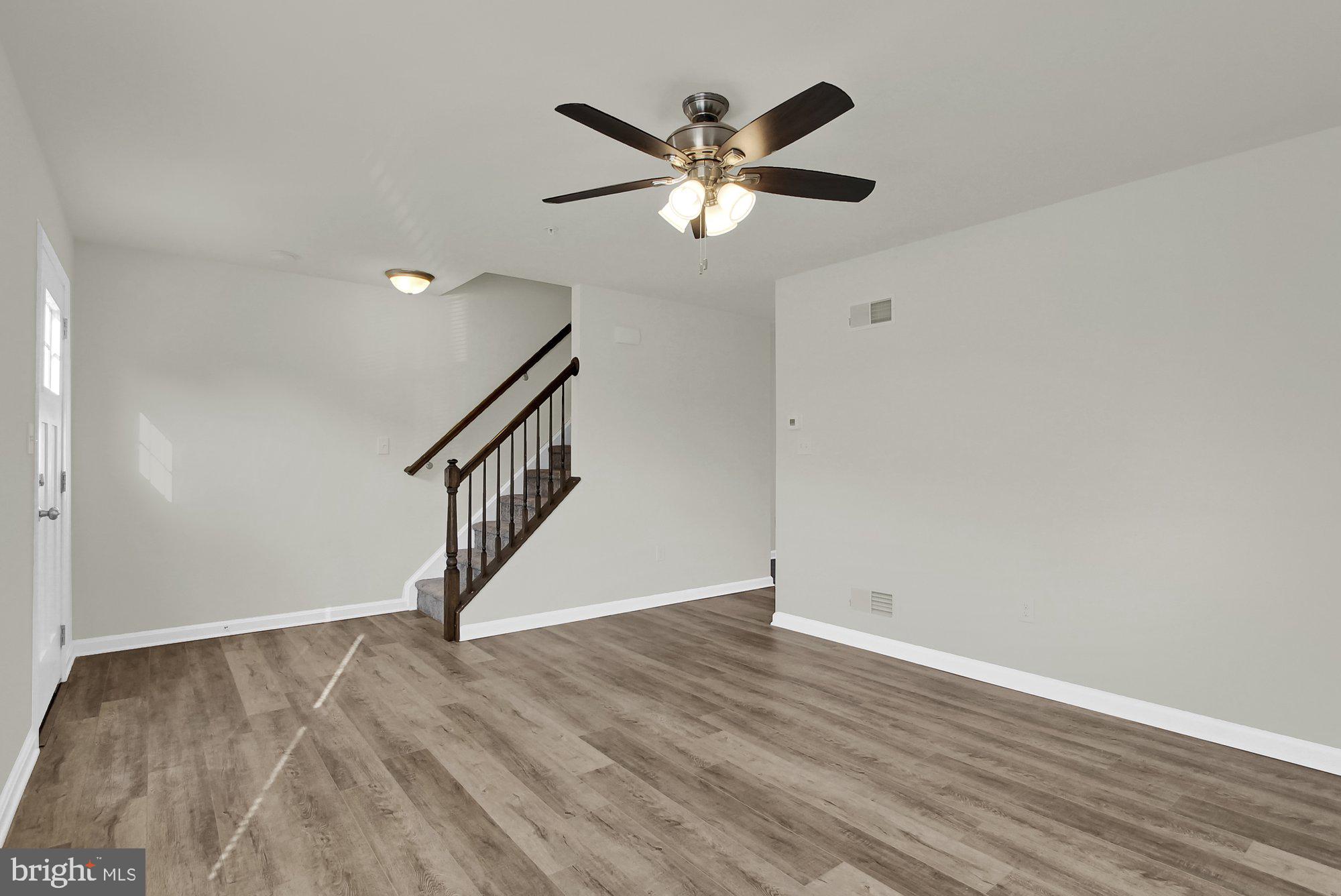 51 Overlook Dr., Unit J Hanover, PA 17331 - Photo 4 of 13 a view of an empty room with wooden floor and a ceiling fan