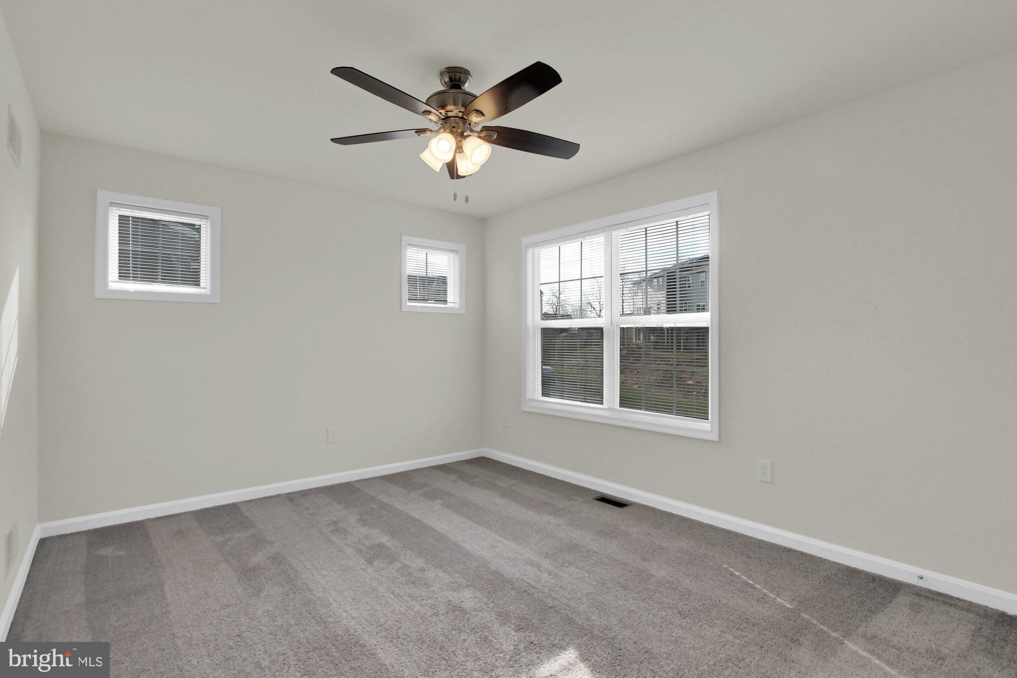 51 Overlook Dr., Unit J Hanover, PA 17331 - Photo 7 of 13 an empty room with windows and fan