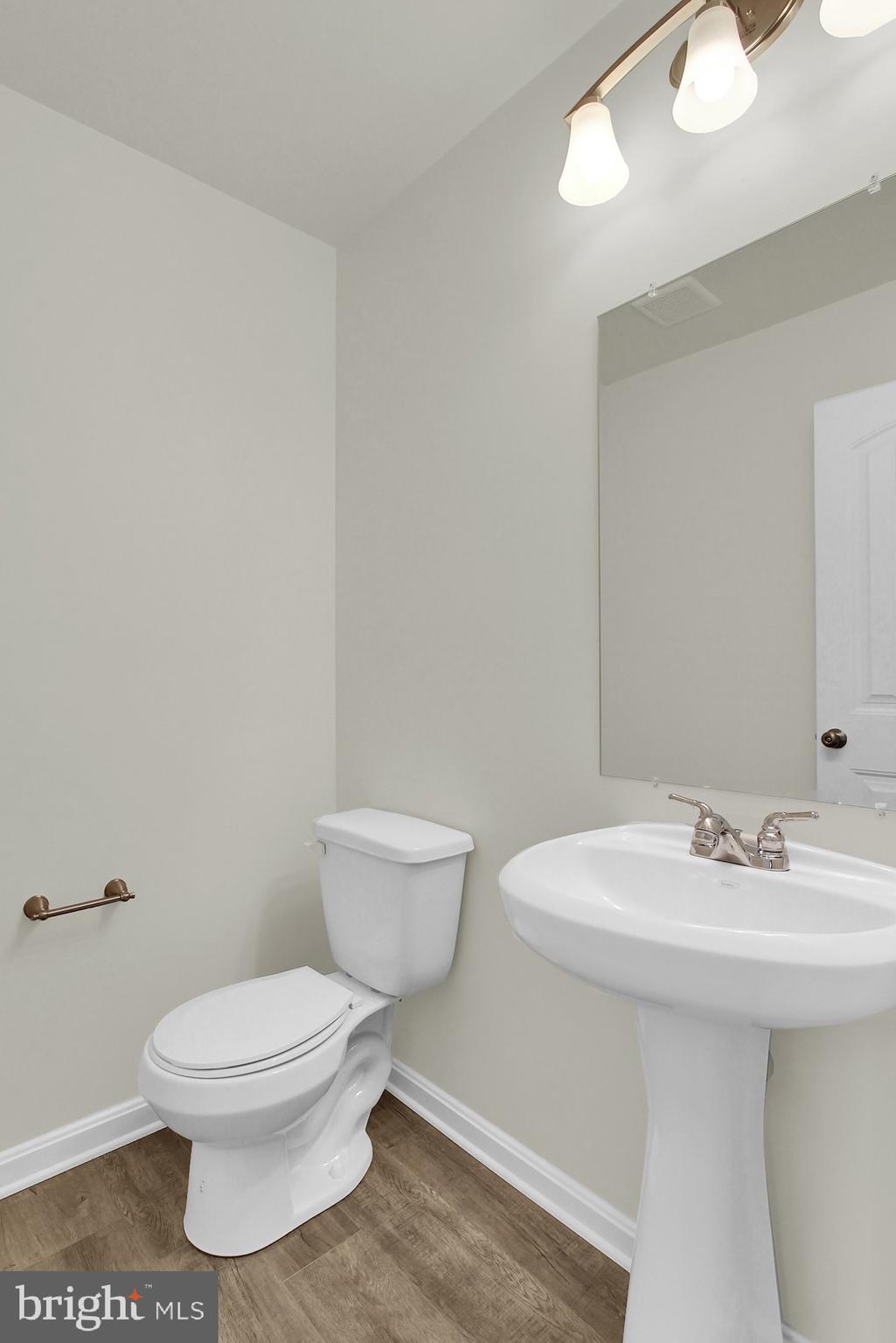 51 Overlook Dr., Unit J Hanover, PA 17331 - Photo 10 of 13 a white toilet sitting next to a bathroom sink