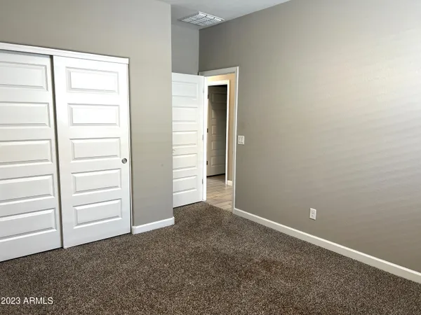 a view of an empty room with closet