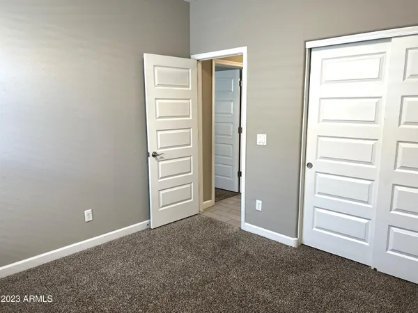 an empty room with closet and bathroom